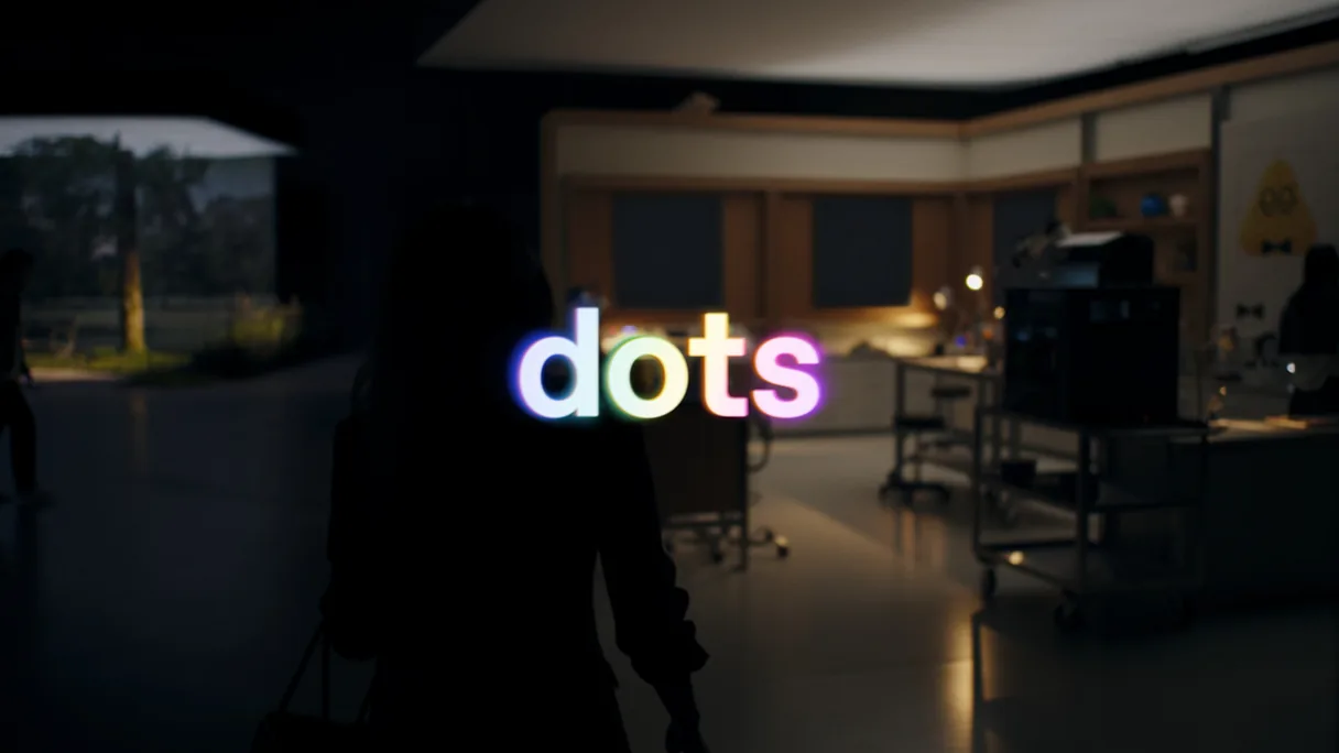 La palabra dots sobre una oficina en penumbra, fotograma del vídeo de presentación de OpenAI